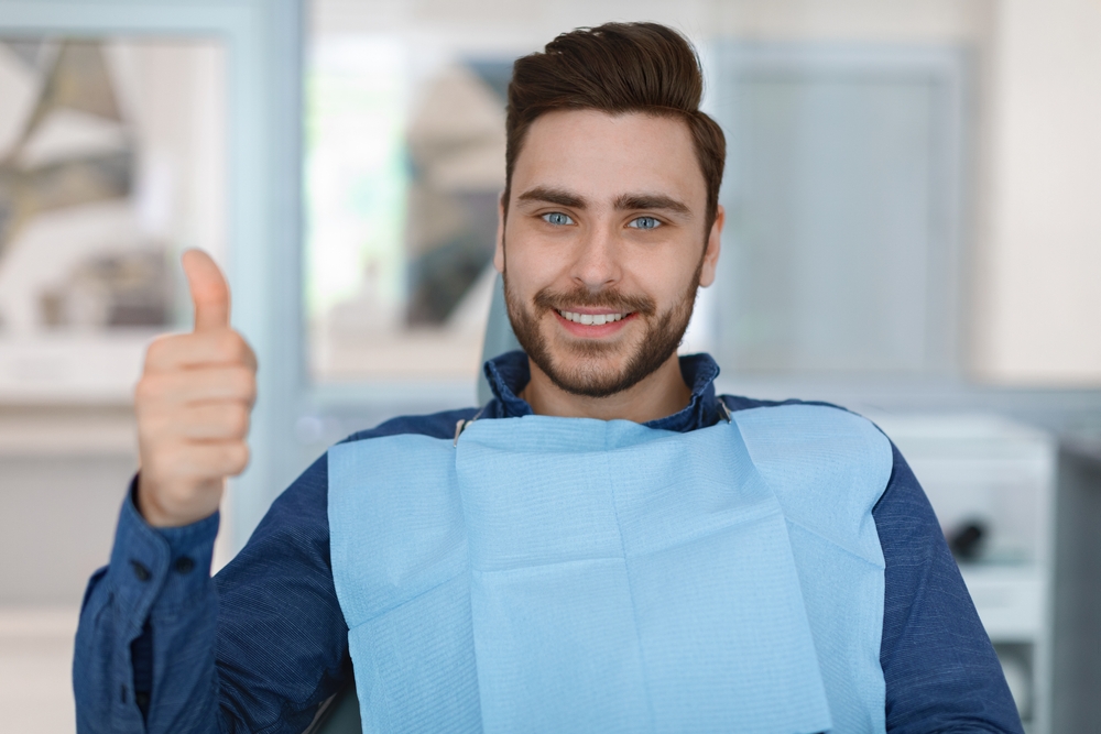 man ready for oral Surgery with thumbs up