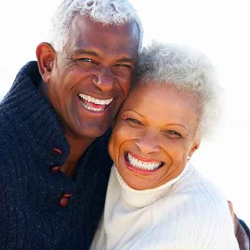 happy older couple with white teeth, implant supported dentures