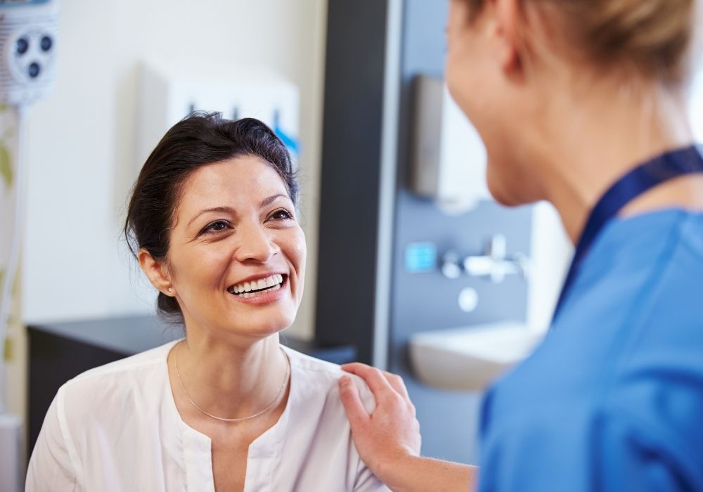doctor speaking with happy patient
