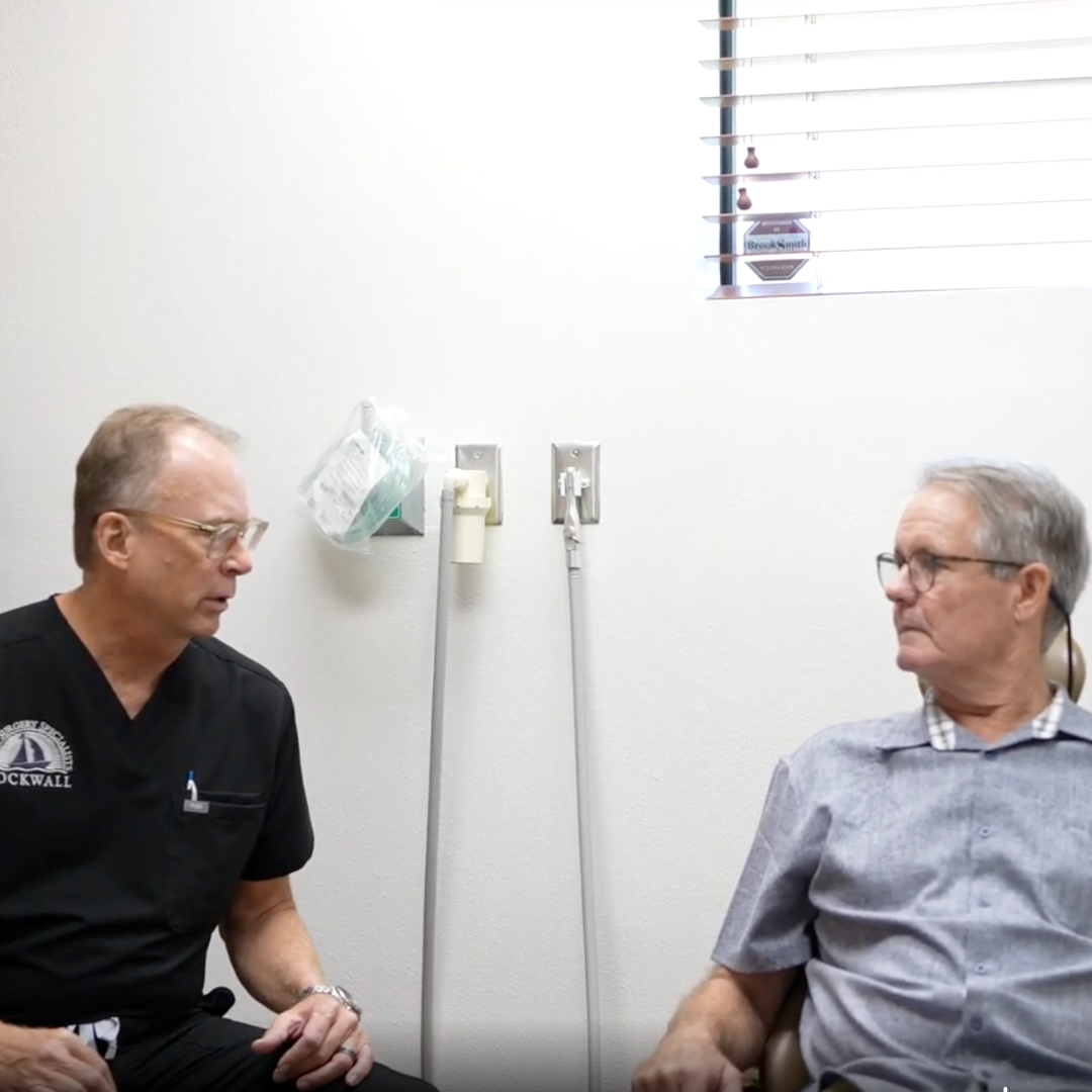 Oral surgeon speaking to patient