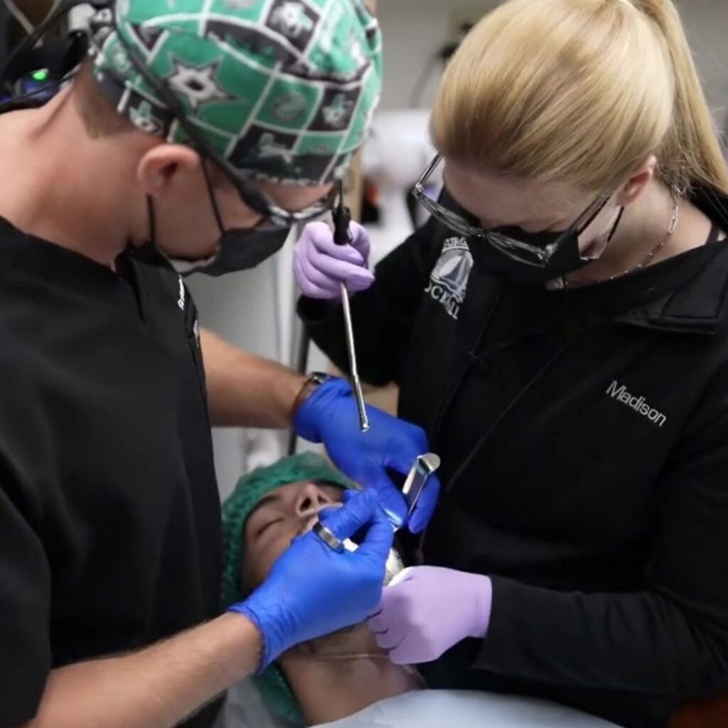 team working on a patient's mouth